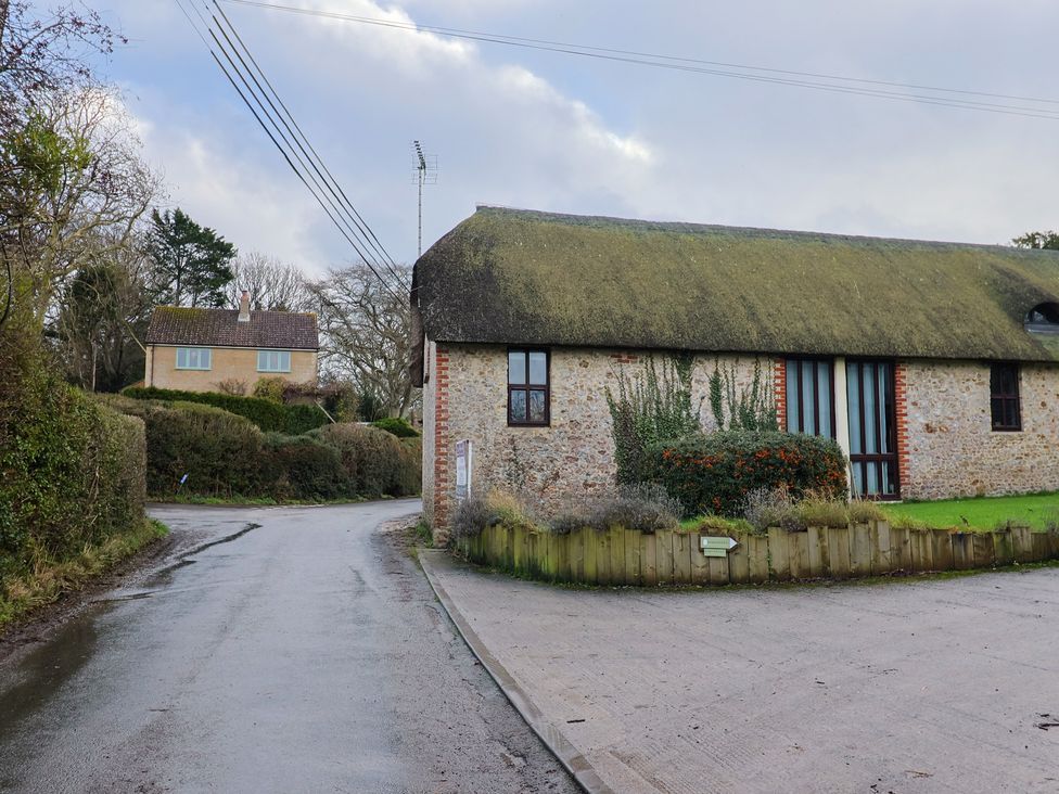 A building with thatched roof and stone wall at Apple Cottage Whitchurch Canonicorum