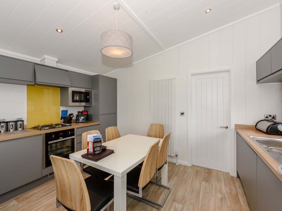 A kitchen with a table and chairs at Blencathra Family in Penrith
