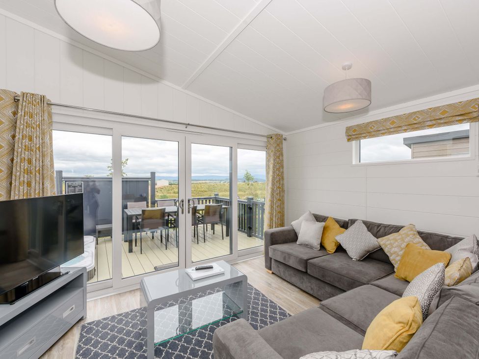 A living room with a sofa and coffee table at Blencathra Family in Penrith