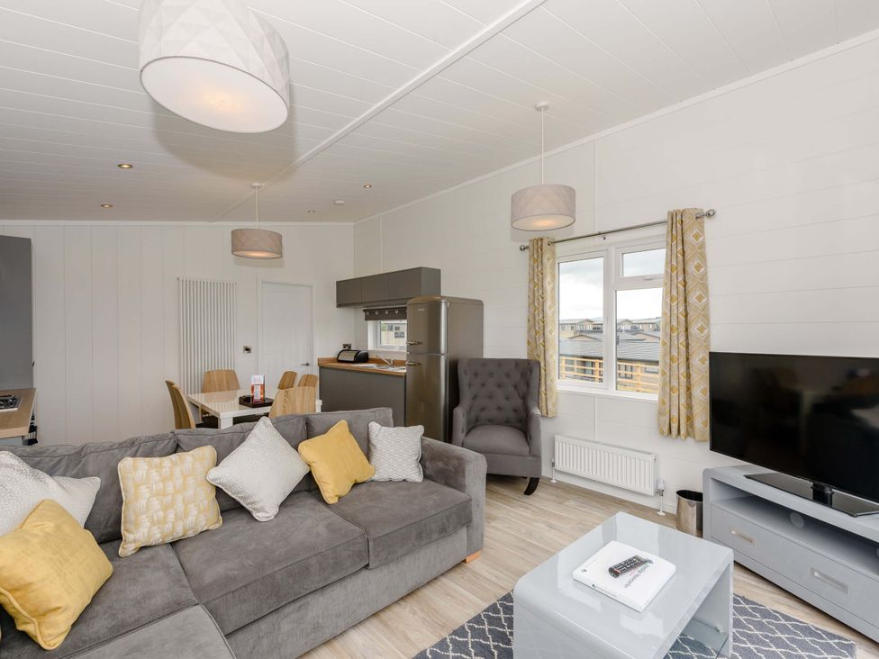 A living room with a sofa and dining table at Blencathra Family in Penrith