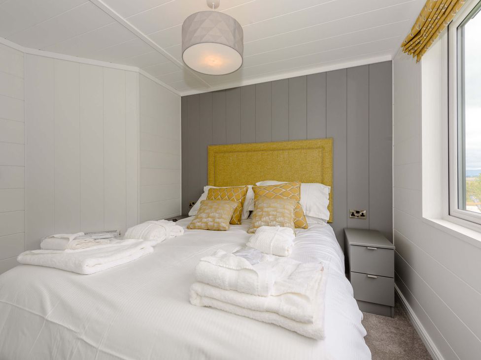 A bedroom with a bed and bedside table at Blencathra Family in Penrith