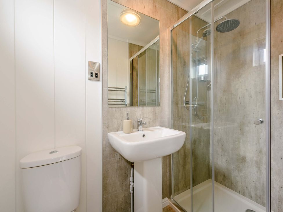A bathroom with a shower, sink, and toilet at Blencathra Family in Penrith