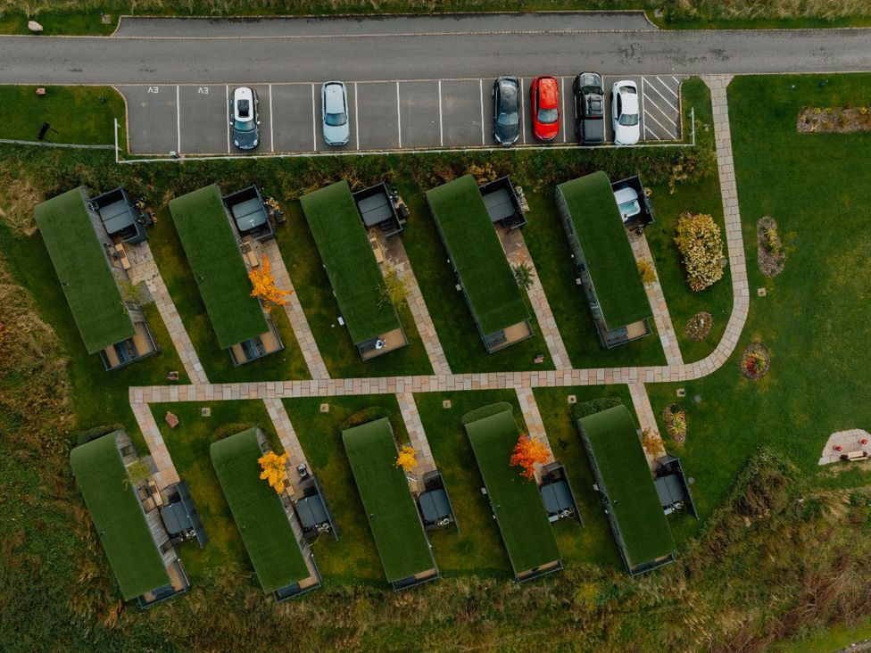 An outdoor area with cabins and a parking lot at Blencathra Family in Penrith