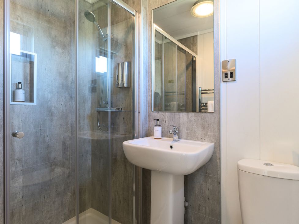 A bathroom featuring a shower, sink and toilet at Blencathra Family (Pet) Penrith