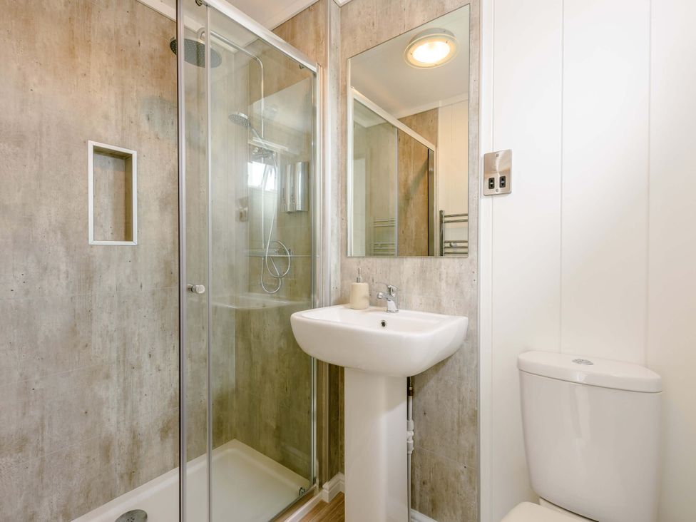 A bathroom with a shower, sink and toilet at Blencathra Family (Pet) in Penrith