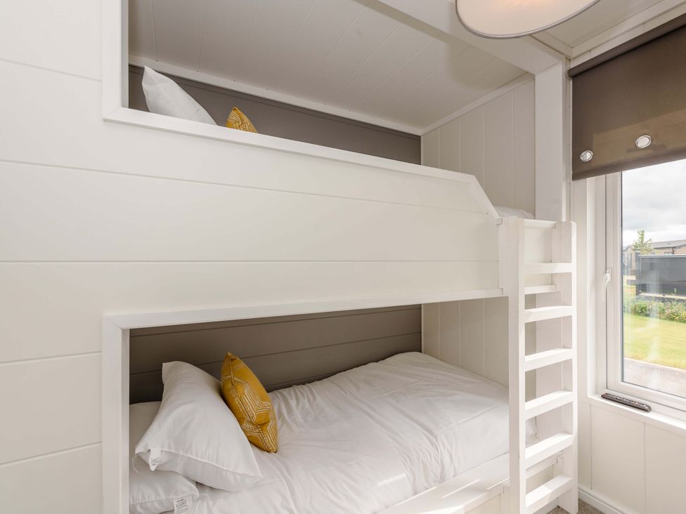 A bedroom with a bunk bed and a window at Blencathra Family (Pet) Penrith