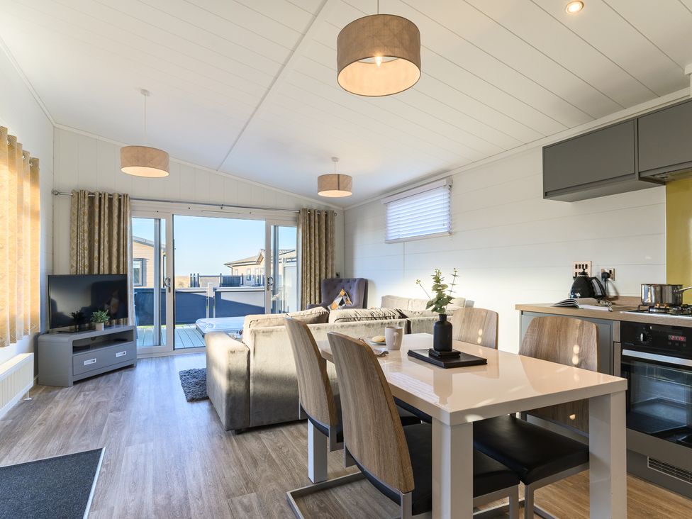 A living room with a dining area and kitchen unit at Grasmere in Penrith