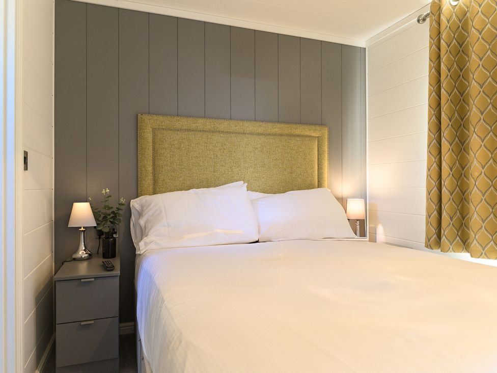 A bedroom with a bed and bedside lamps at Grasmere in Penrith