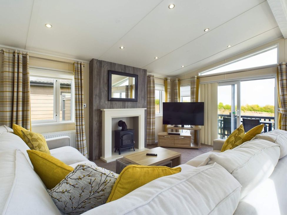 A living room with a sofa and TV at Keswick in Penrith