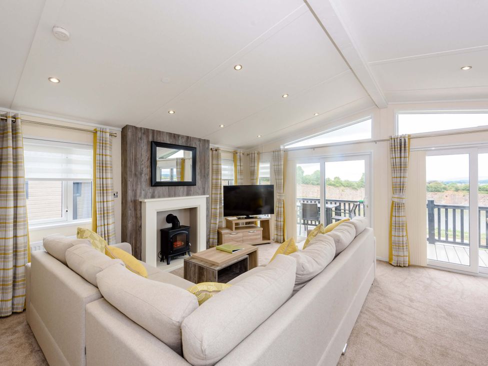 A living room with a television and fireplace at Keswick in Penrith
