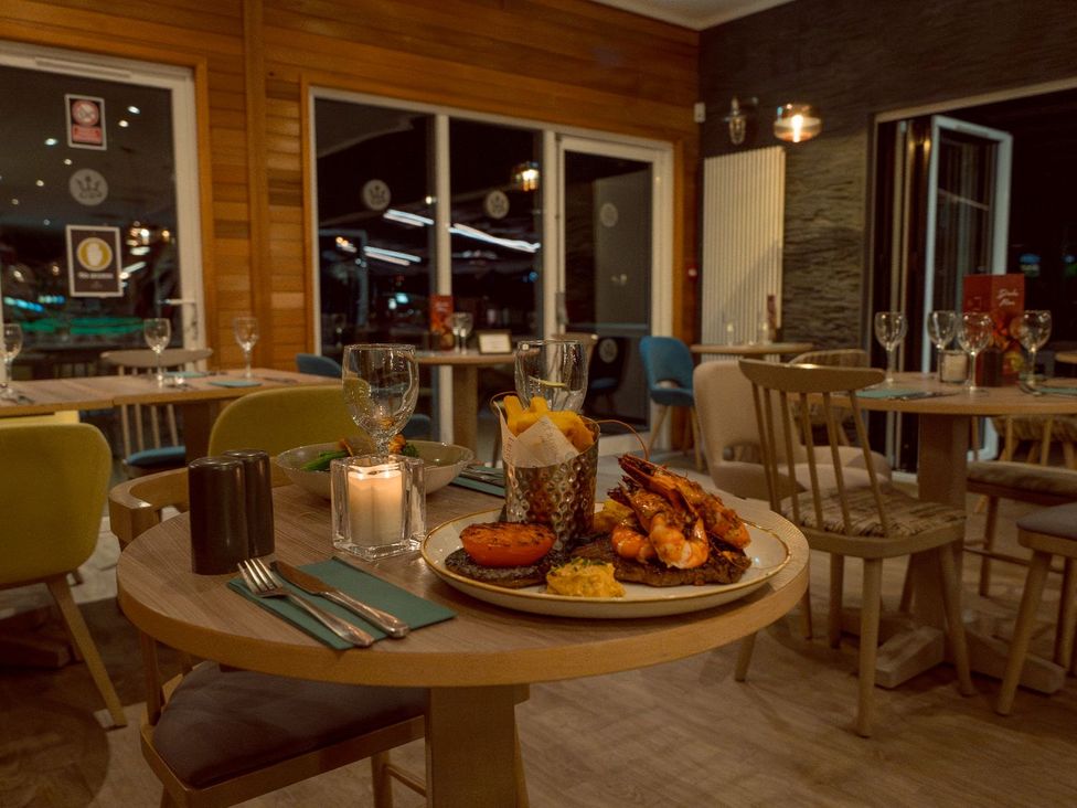A restaurant interior with tables and food served at Keswick in Penrith