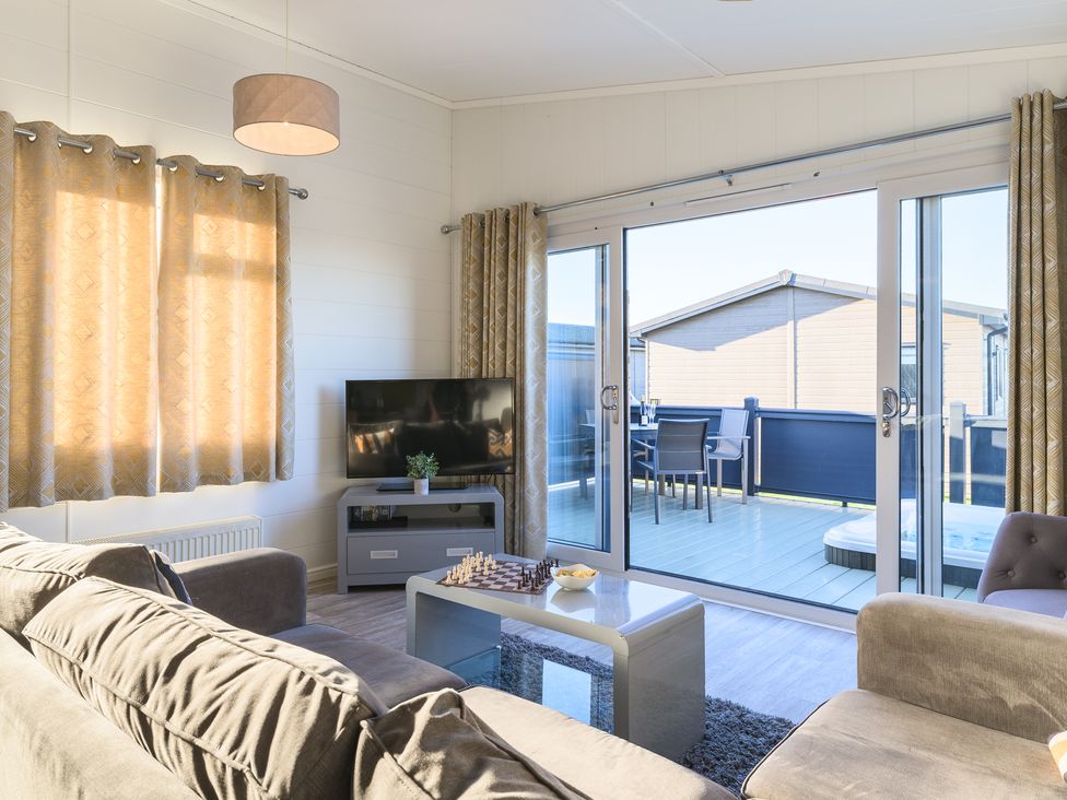 A living room with a sofa and television at Grasmere (Pet) Penrith