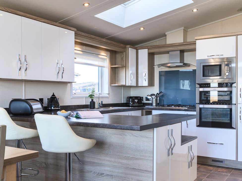 A kitchen with modern appliances at Keswick (Pet) Penrith