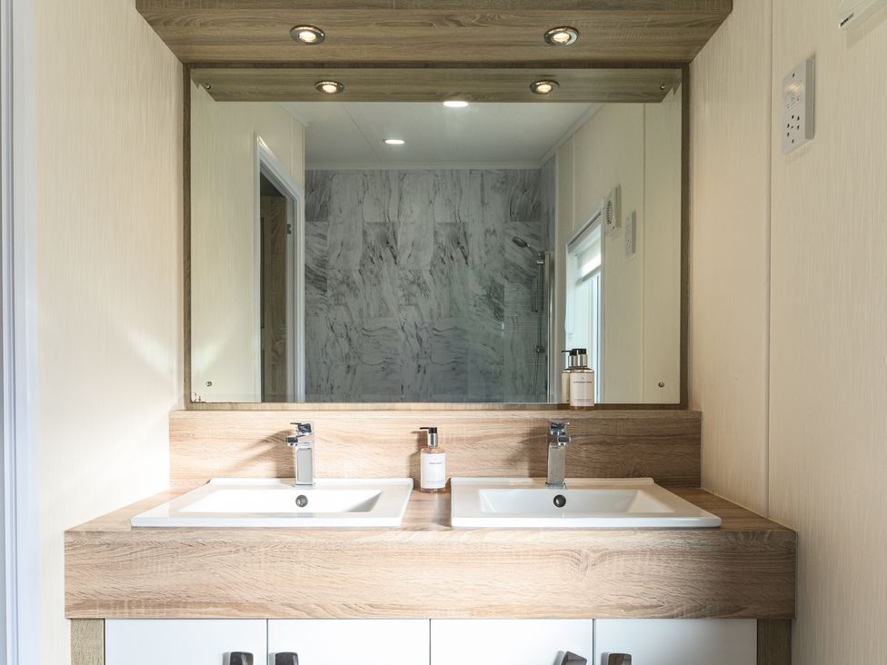 A bathroom with two sinks and a shower at Keswick (Pet) Penrith