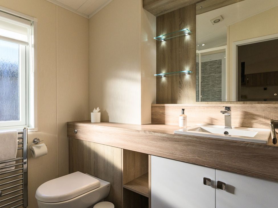 A bathroom with a sink and toilet at Keswick (Pet) in Penrith