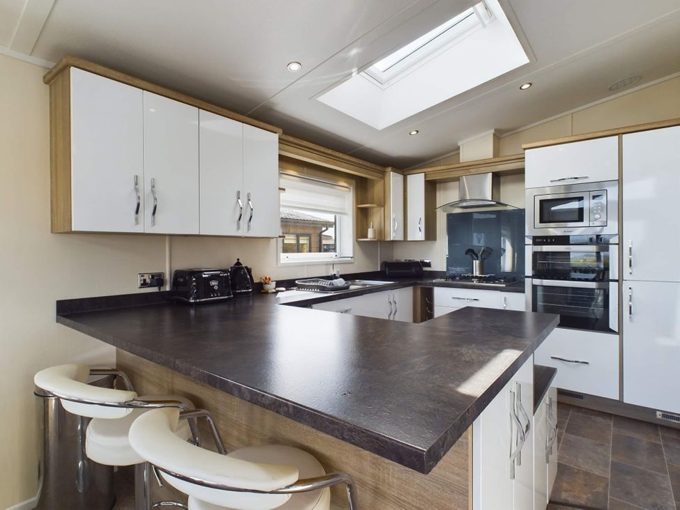 A kitchen with cabinets and appliances at Keswick (Pet) Penrith