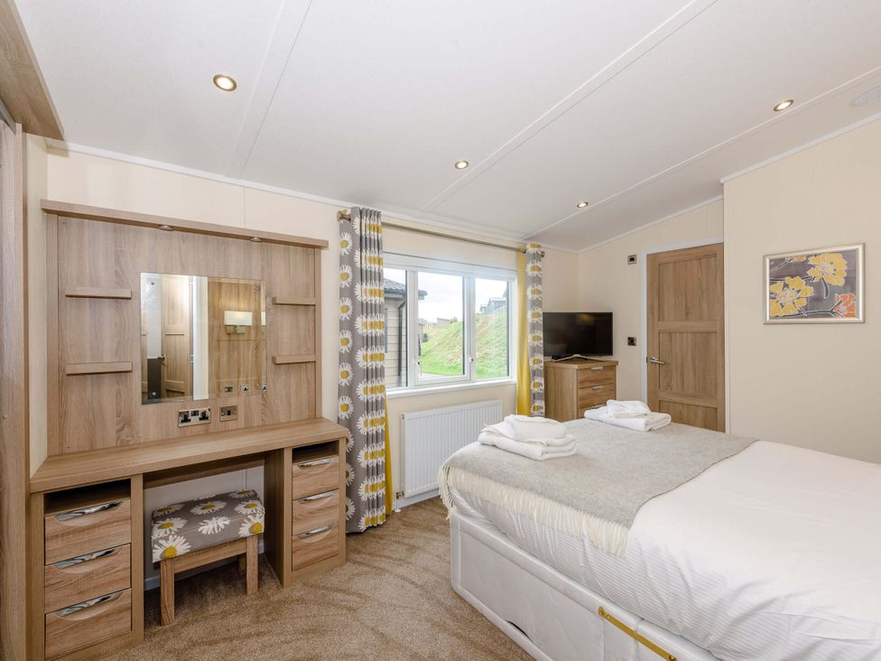 A bedroom with a bed and a window at Keswick (Pet) Penrith
