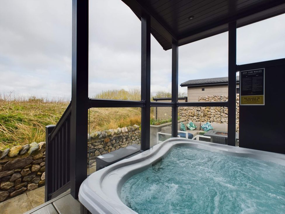 An outdoor hot tub with views in the Spa Sauna Lodge Penrith
