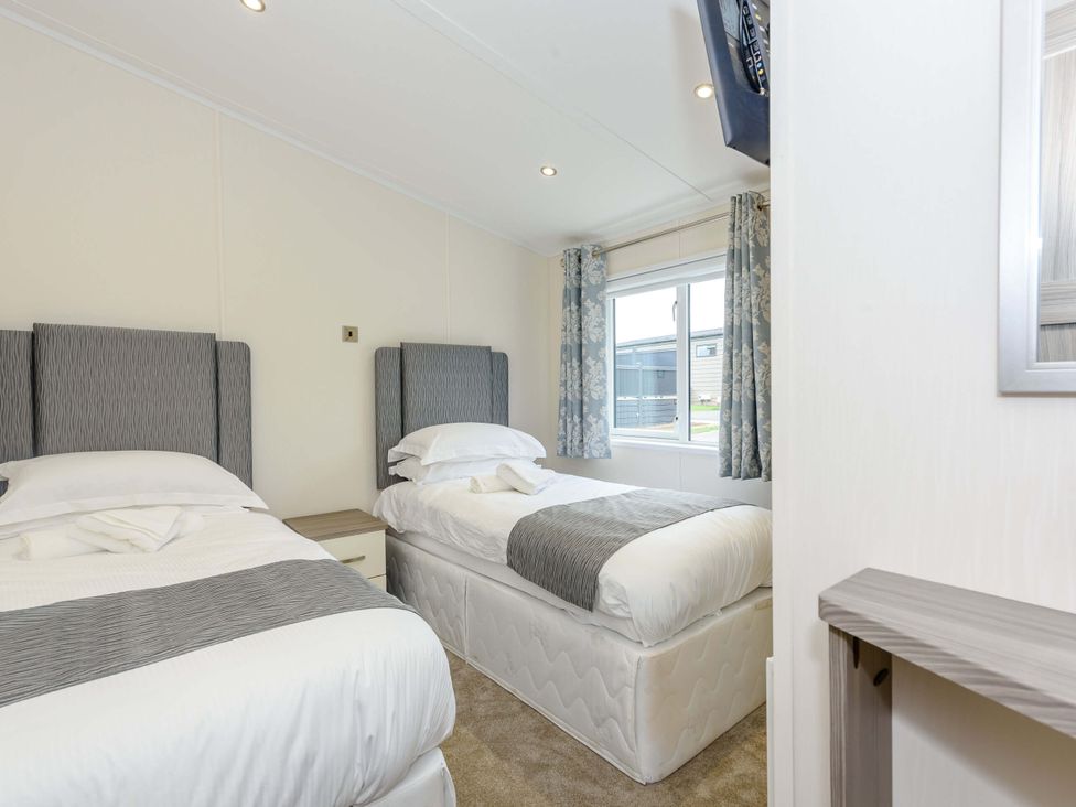 A bedroom with two beds and a window at Helvellyn in Penrith