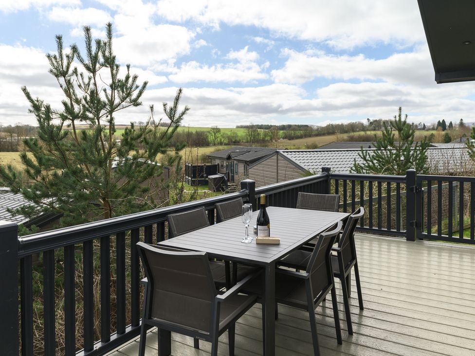 A deck with a table and chairs at Helvellyn (Pet) in Penrith