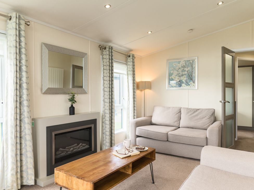 A living room with a sofa and table at Helvellyn (Pet) in Penrith