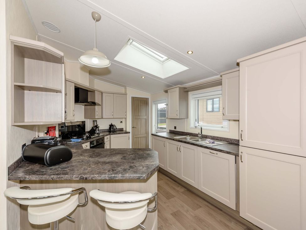 A kitchen with cabinets and a countertop at Helvellyn (Pet) Penrith