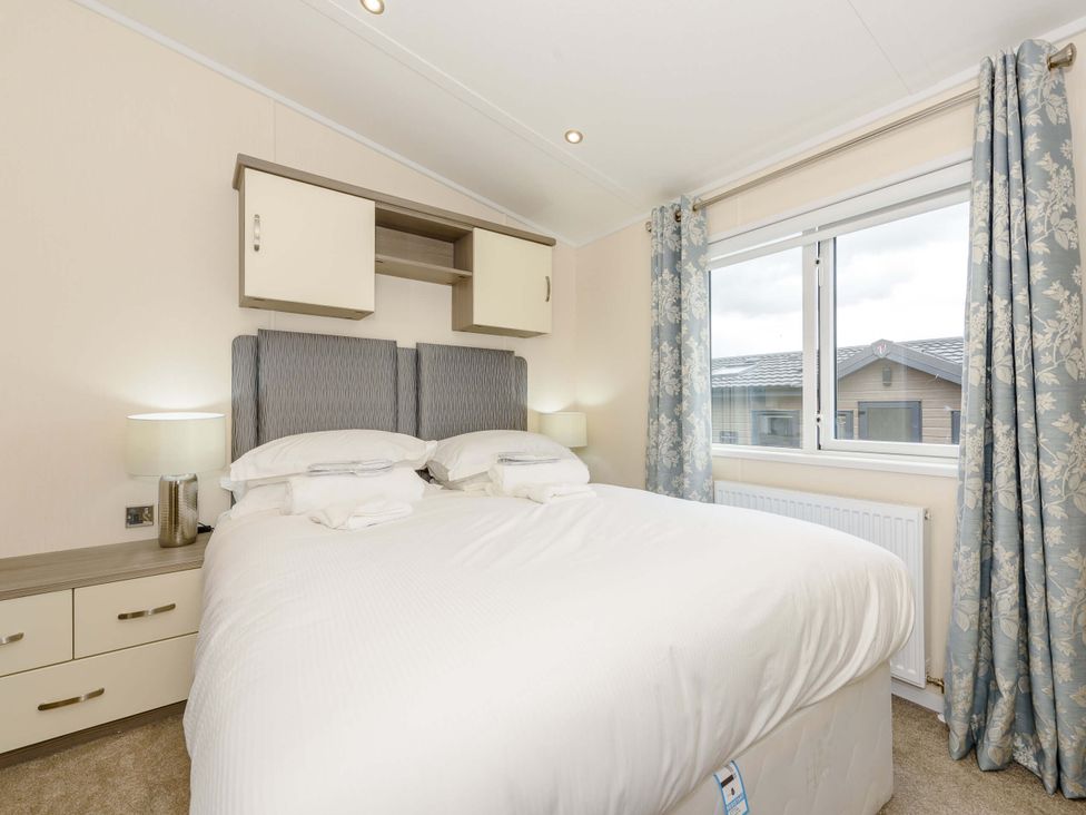 A bedroom with a bed and window at Helvellyn (Pet) Penrith