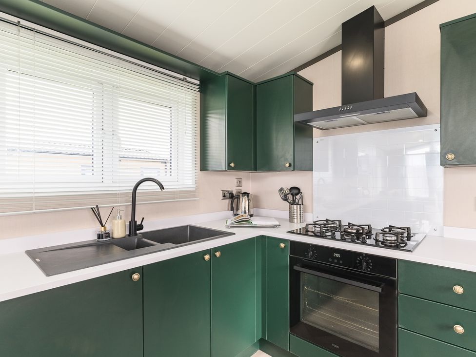 A kitchen with a sink and cooker at Blencathra Spa (Pet) in Penrith