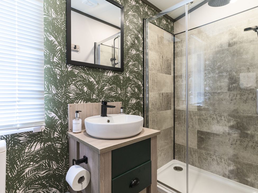 A bathroom with a sink and shower at Blencathra Spa (Pet) in Penrith