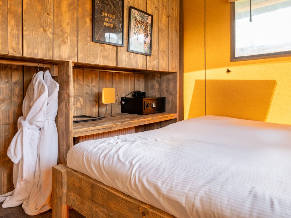 A bedroom with a bed and shelf with a safe at Kruger in Penrith