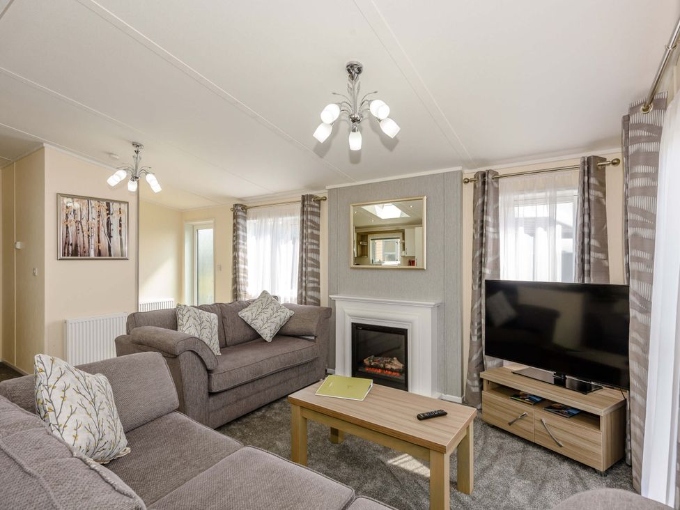 A living room with a sofa and television at Scaféll in Penrith