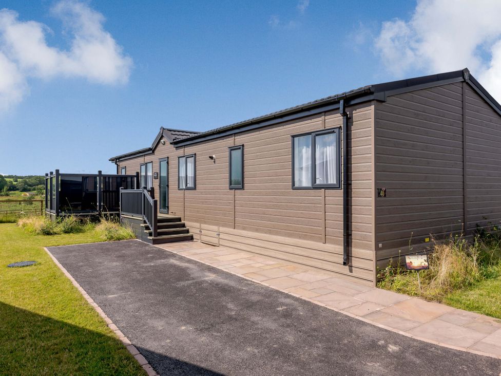 A mobile home with steps and a patio area at Scaféll (Pet) in Penrith