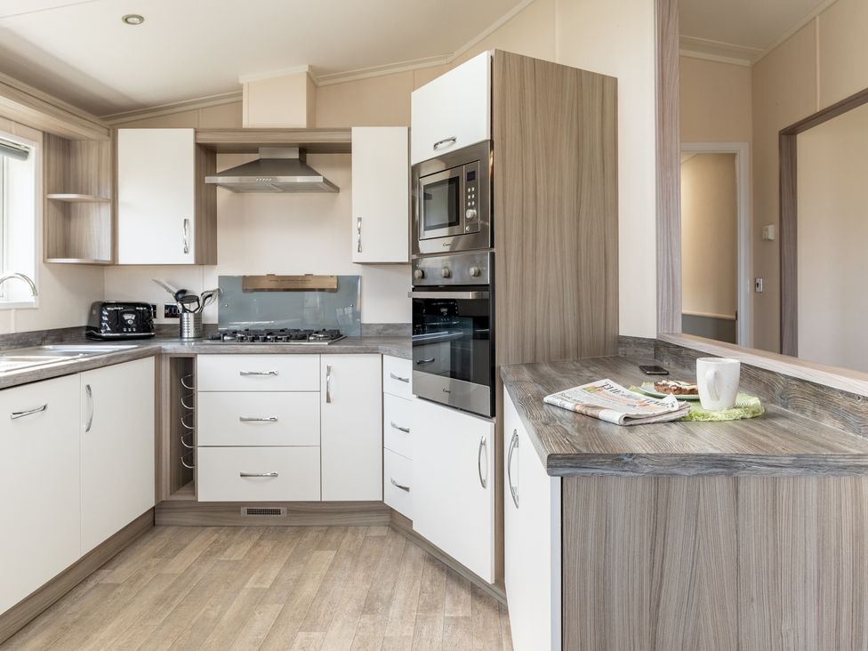 A kitchen with cabinets and appliances at Scaféll (Pet) in Penrith