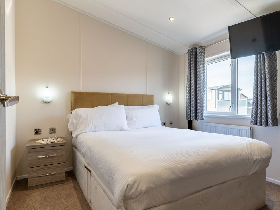 A bedroom with a double bed and nightstand at Scaféll (Pet) in Penrith