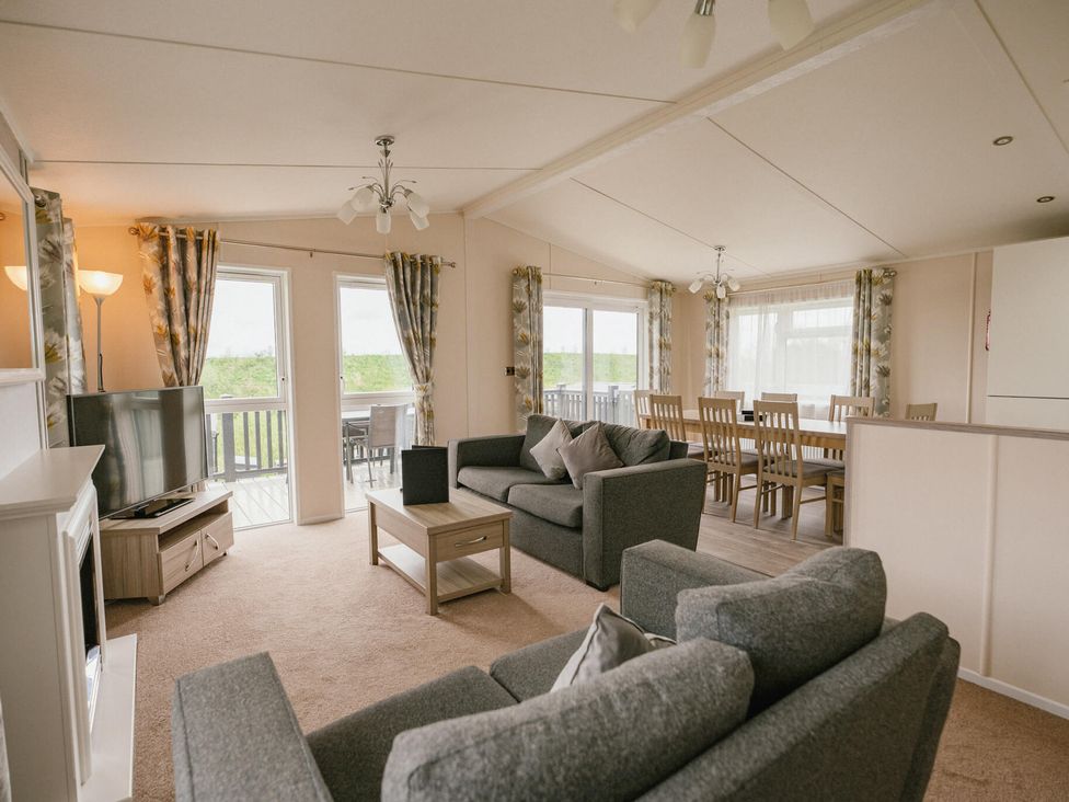 A living room with a sofa and television at Scaféll (Pet) in Penrith