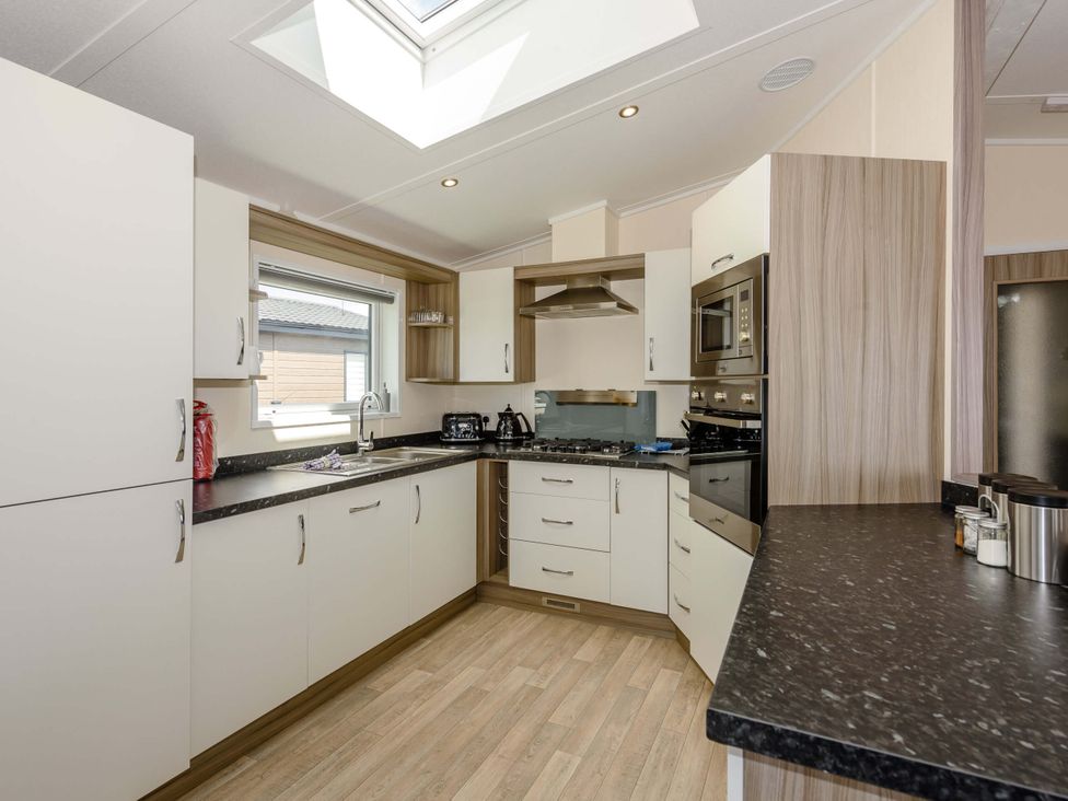 A kitchen with cabinets and appliances at Scaféll (Pet) in Penrith