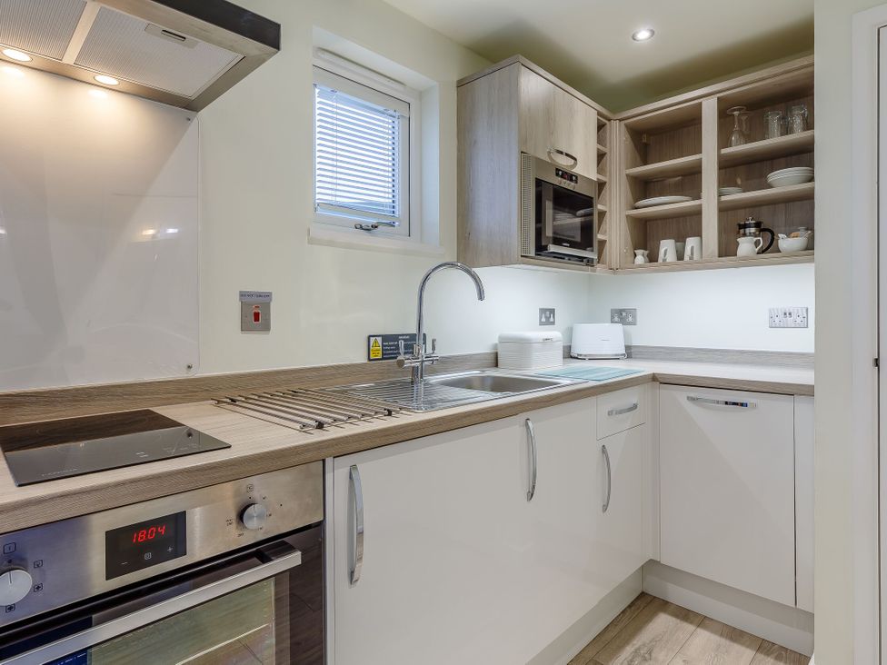 A kitchen with a sink and cooking appliances at Lakeside Studio Pet in Portreath