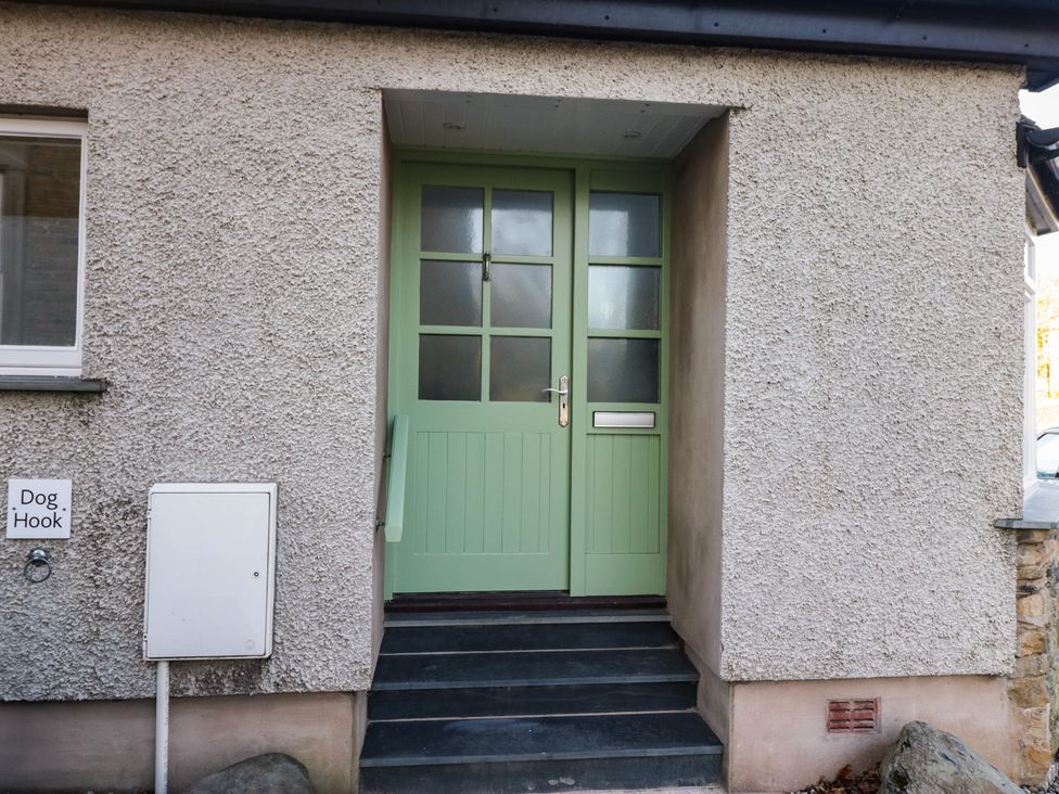 An entrance with a green front door and a dog hook at Renes Shop in Grange-Over-Sands