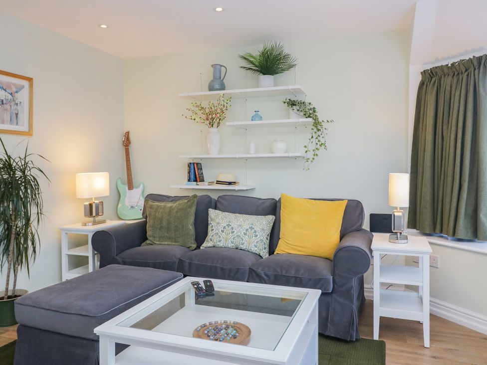 A living room with a sofa and decorations at Renes Shop in Grange-Over-Sands
