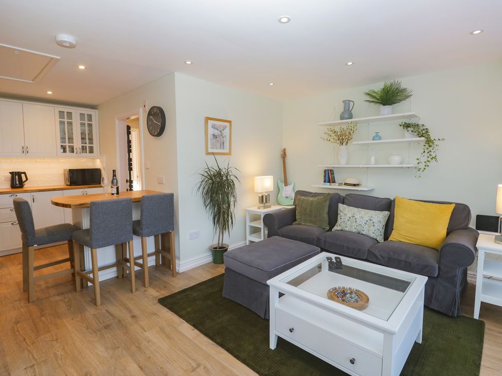 A living room with a sofa and dining area at Renes Shop in Grange-Over-Sands