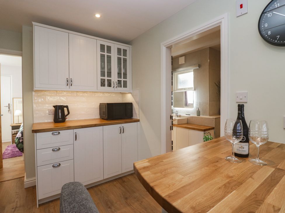 A kitchen with a microwave and kettle at Renes Shop in Grange-Over-Sands