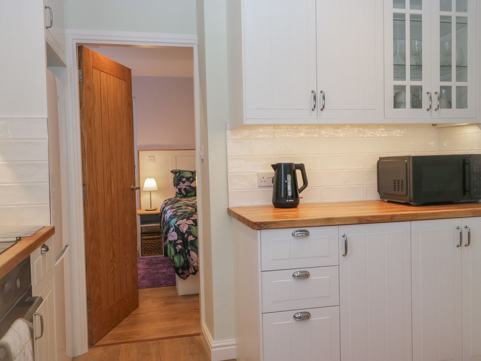 A kitchen with a kettle and microwave at Renes Shop in Grange-Over-Sands
