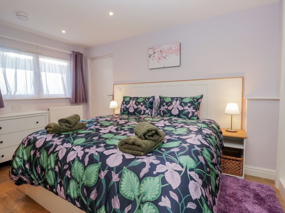 A bedroom with a double bed and bedside lamps at Renes Shop in Grange-Over-Sands