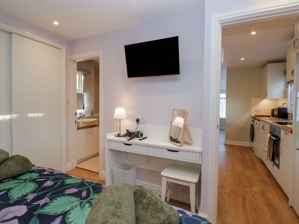 A bedroom with a bed and desk at Renes Shop in Grange-Over-Sands