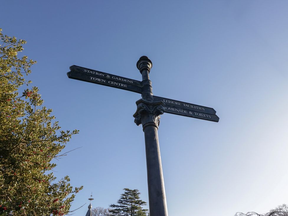 A signpost indicating directions at Renes Shop in Grange-Over-Sands