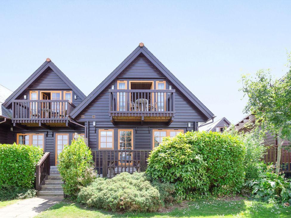 A house with balconies and greenery at Scandinavian Lodge 4 in Portreath