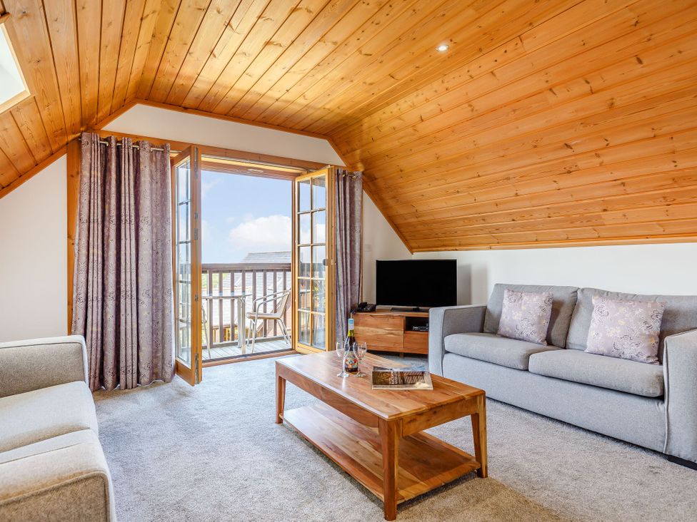 A living room with a sofa and coffee table at Scandinavian Lodge 4 Portreath