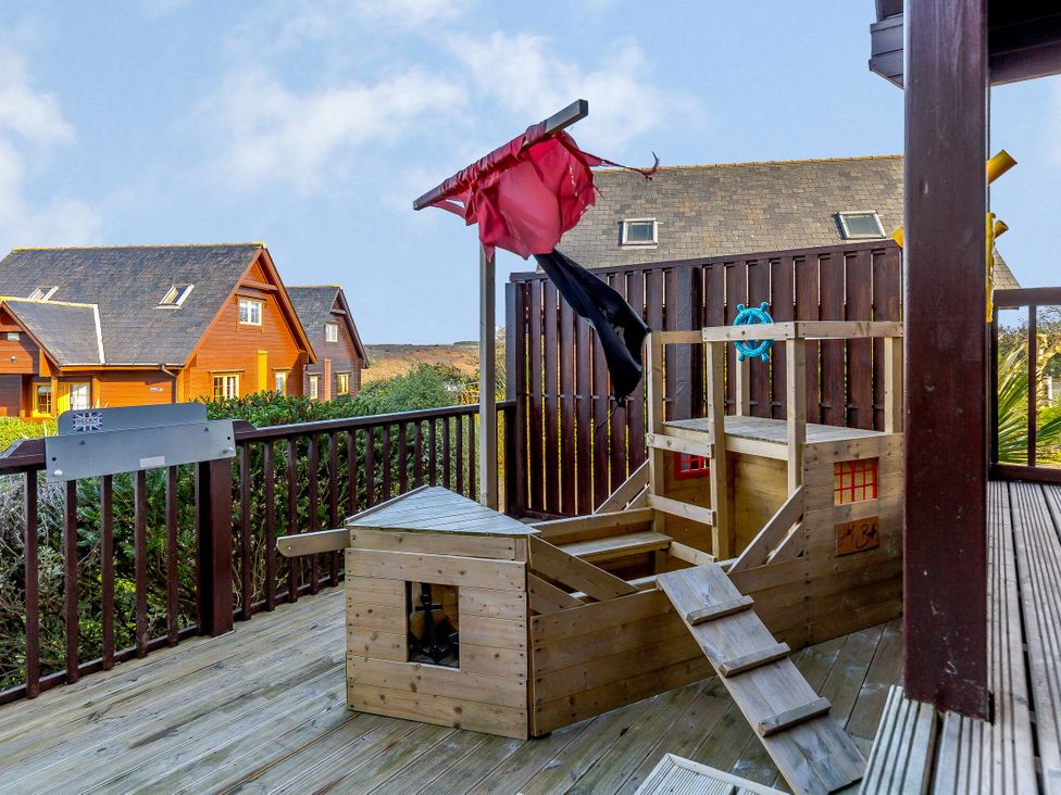 A play structure with a slide and ladder at Kinder Lodge in Portreath