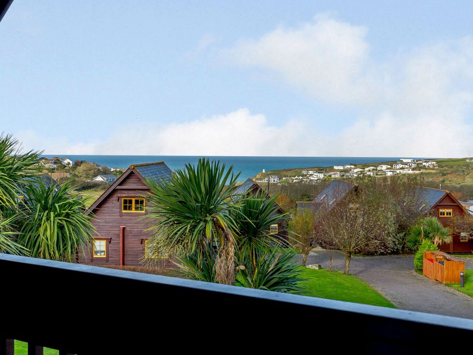 View of houses and sea from a balcony at Kinder Lodge in Portreath