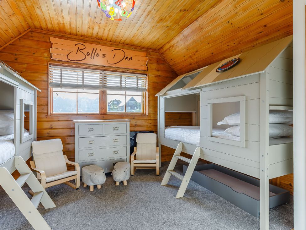 A bedroom with bunk beds and a dresser at Kinder Lodge in Portreath